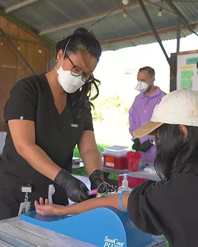 Post-baccalaureate phlebotomist Rosa Lee obtains blood from through venipuncture.