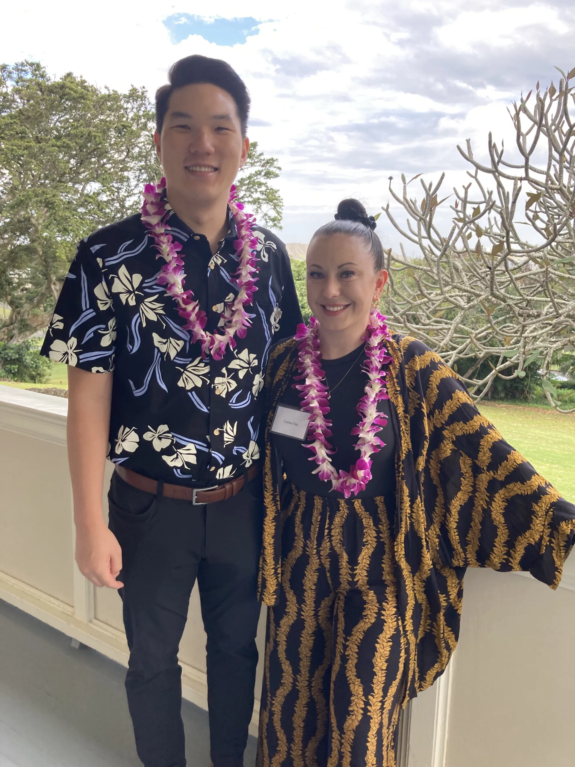 Lei-bedecked man and woman on College Hill lanai